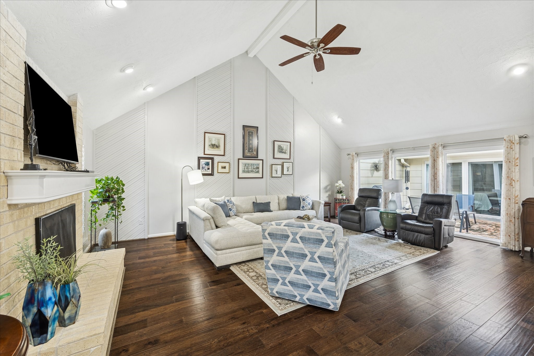 a living room with furniture fireplace and flat screen tv