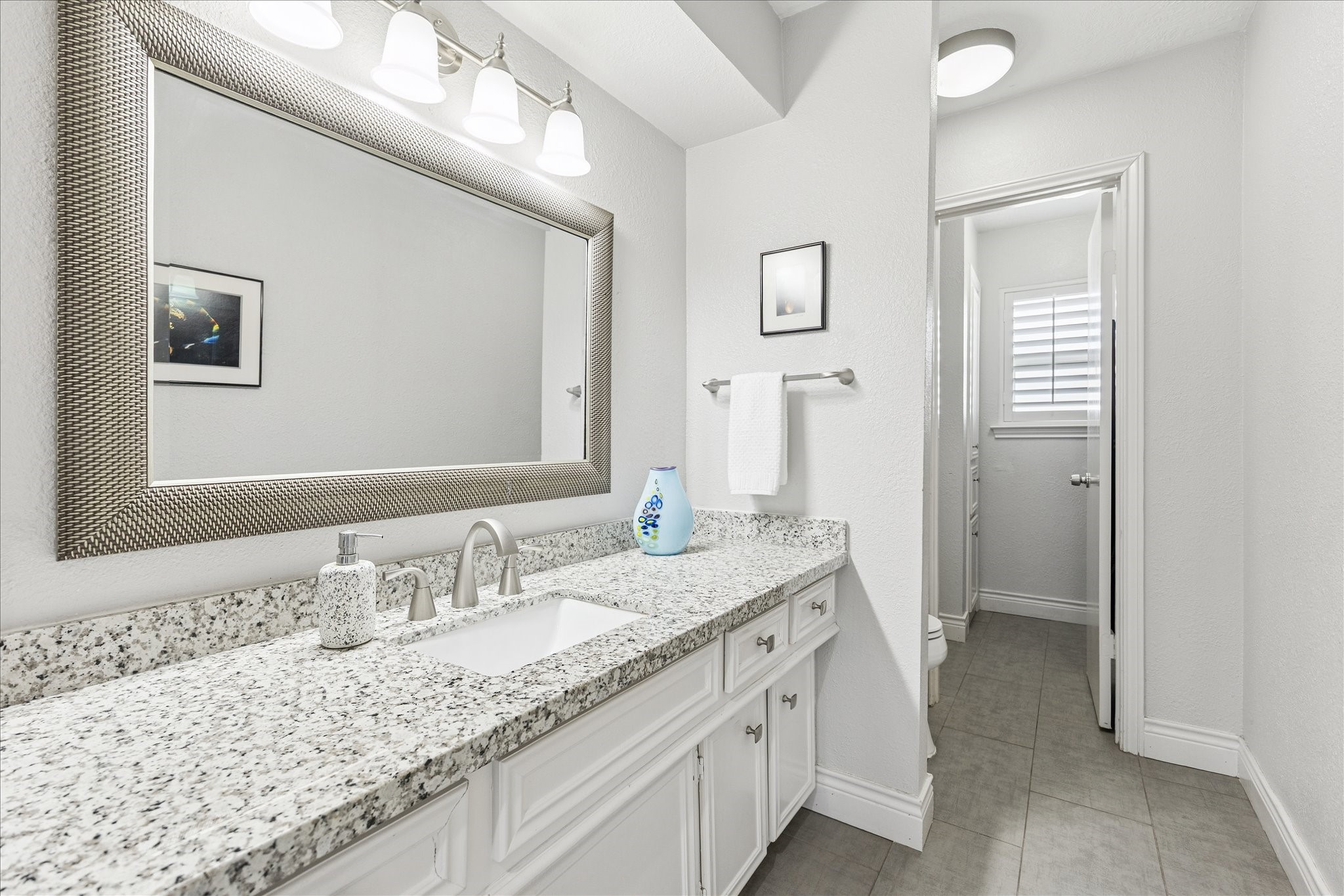 2930 Teague Road Houston, TX 77080 - Photo 17 of 22 a bathroom with a granite countertop sink and a mirror