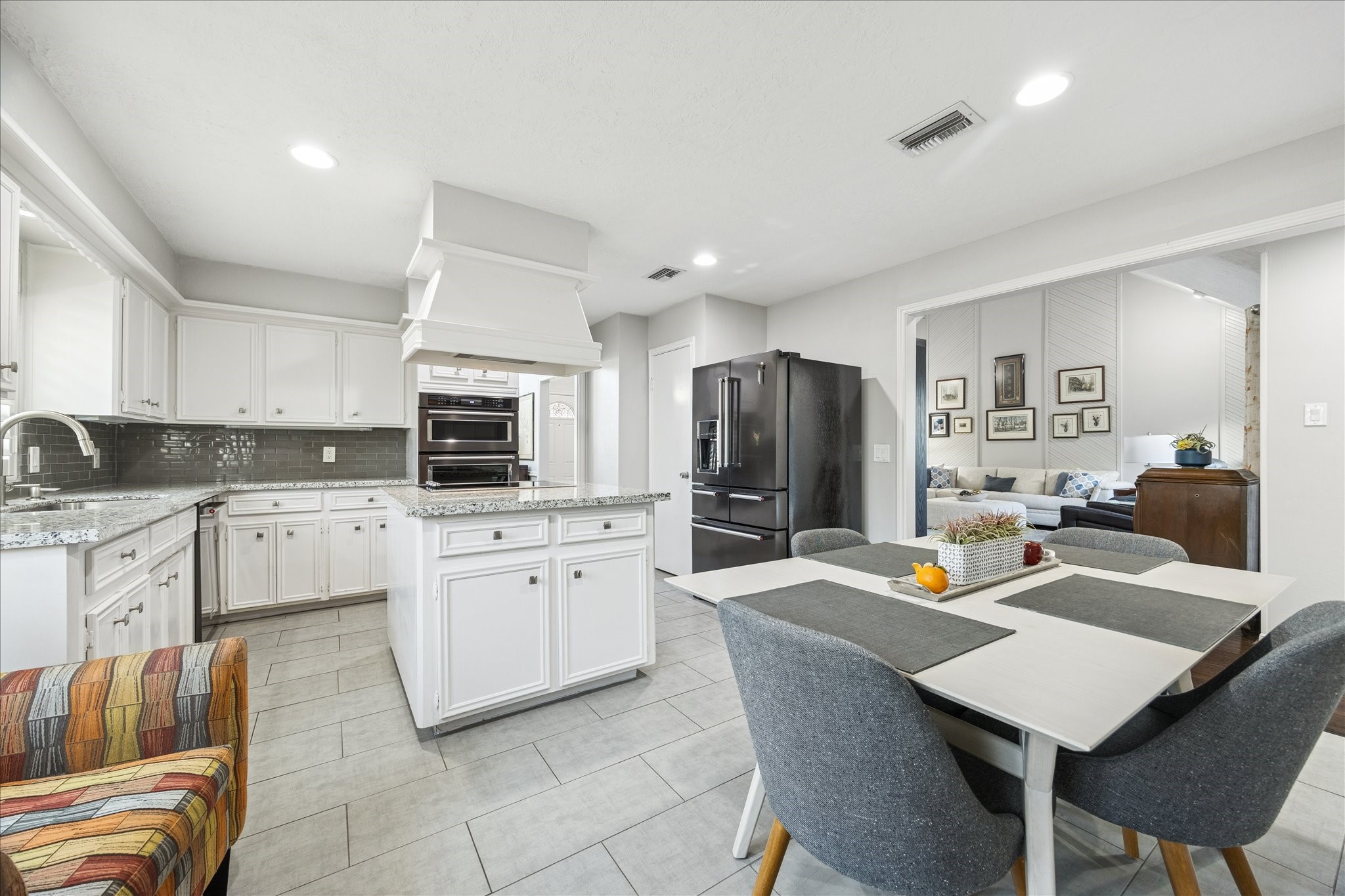 2930 Teague Road Houston, TX 77080 - Photo 3 of 22 a large kitchen with kitchen island granite countertop a stove a sink a dining table and chairs