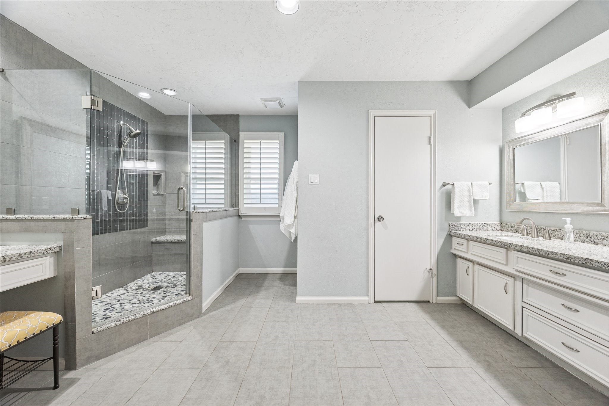 2930 Teague Road Houston, TX 77080 - Photo 4 of 22 a bathroom with a granite countertop sink a toilet a glass door shower and a mirror
