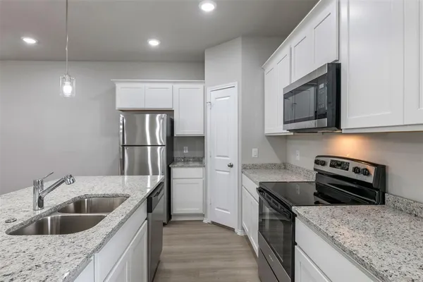 a kitchen with a sink stove and refrigerator