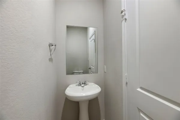 a bathroom with a sink a mirror and toilet
