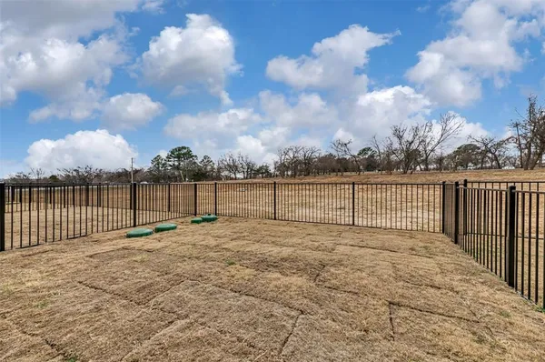 a view of outdoor space with wooden fence