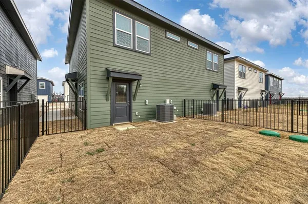 a view of a house with a wooden fence