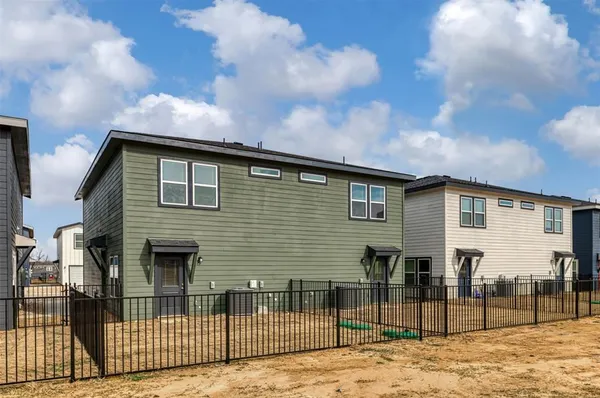 a front view of a house with wooden fence