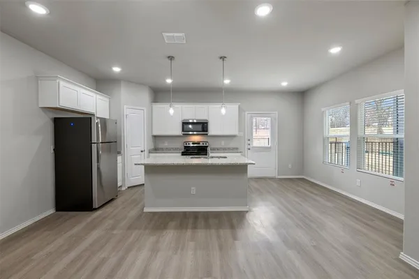 a view of kitchen with refrigerator and window
