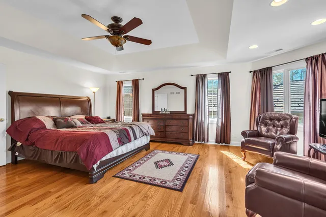 a bedroom with a large bed a couch and a window