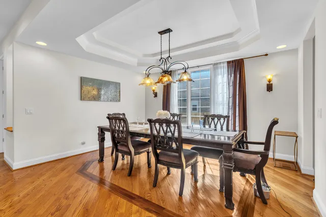 a dining room with furniture and wooden floor