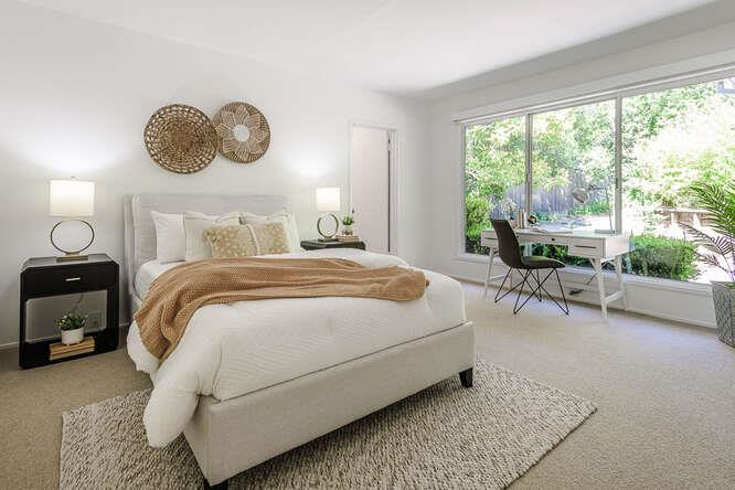 745 Bromfield Road Hillsborough, CA 94010 - Photo 28 of 42 a bedroom with a large bed and a chandelier