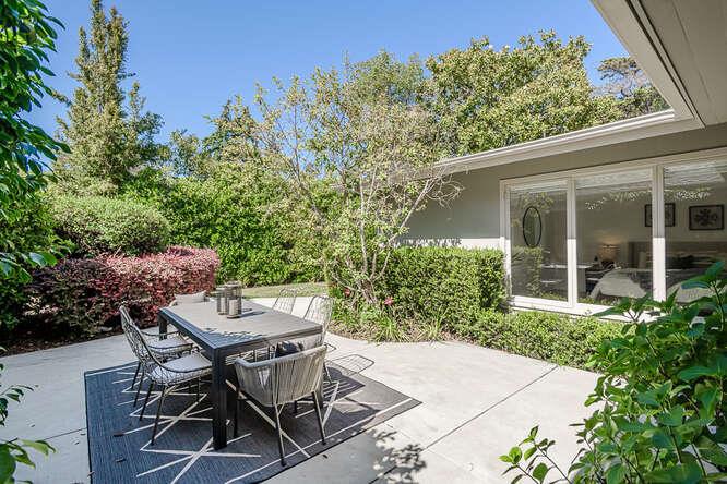745 Bromfield Road Hillsborough, CA 94010 - Photo 34 of 42 a view of a patio with table and chairs and potted plants