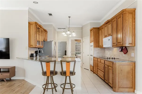 a kitchen with stainless steel appliances kitchen island granite countertop a sink and cabinets