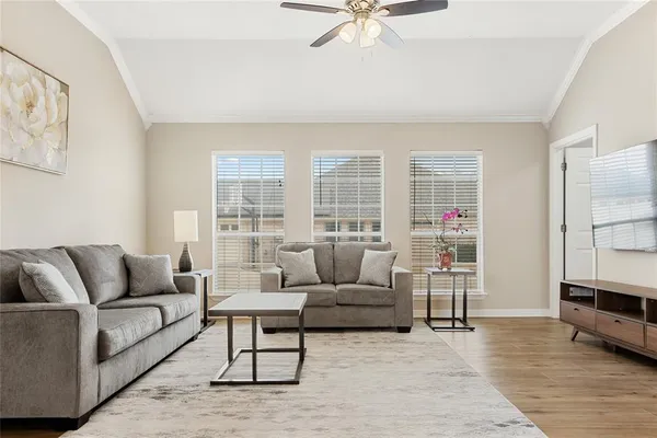 a living room with furniture and a large window