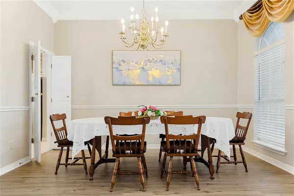 a view of a dining room with furniture and chandelier
