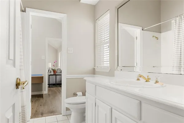 a bathroom with a sink and mirror with toilet