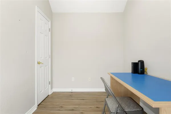 a view of a workspace with furniture and wooden floor