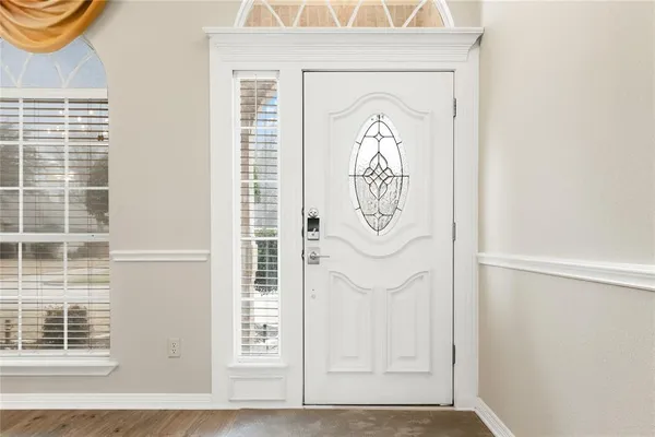 a view of a hallway with wooden door