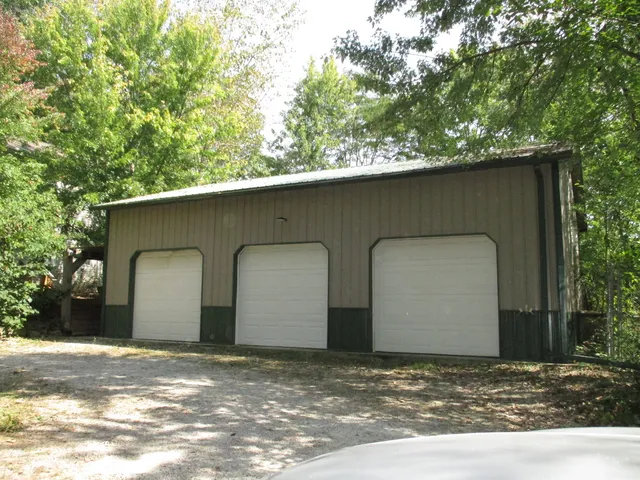 a view of a house with a yard and garage