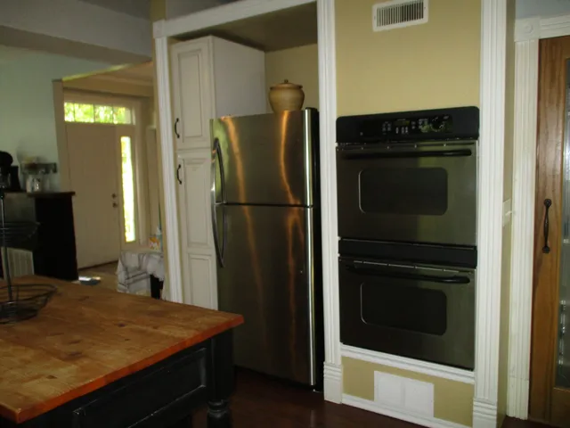 a kitchen with a refrigerator and cabinets