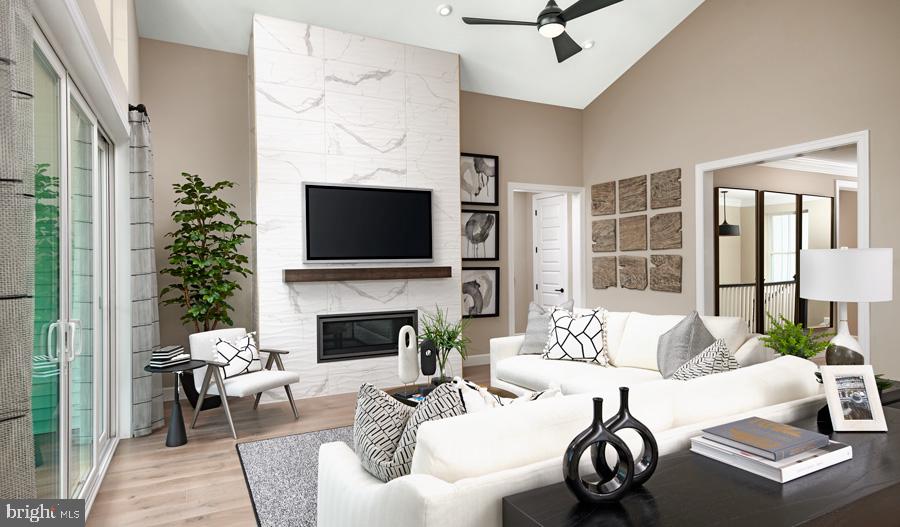 101 Abrams Pointe Boulevard Winchester, VA 22602 - Photo 2 of 11 a living room with furniture a fireplace and a flat screen tv