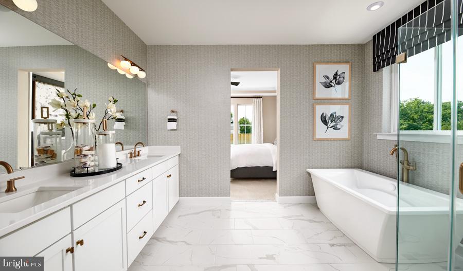 101 Abrams Pointe Boulevard Winchester, VA 22602 - Photo 7 of 11 a spacious en suite bathroom with a tub double sink window and mirror