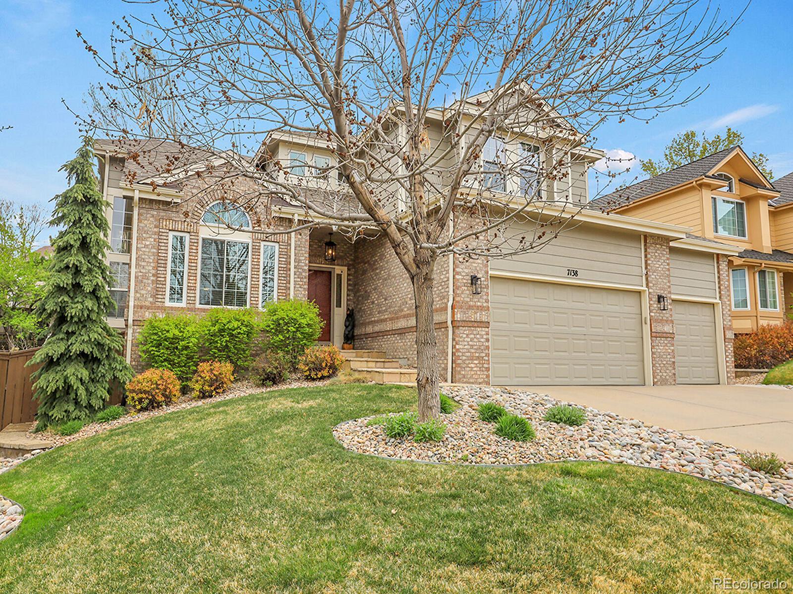 7138 Mountain Brush Circle Highlands Ranch, CO 80130 - Photo 1 of 50 a front view of house with yard and trees
