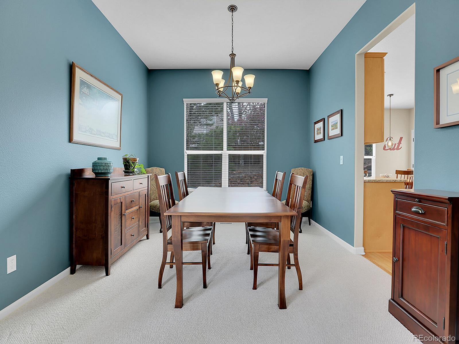 7138 Mountain Brush Circle Highlands Ranch, CO 80130 - Photo 15 of 50 a view of a dining room with furniture window and wooden floor
