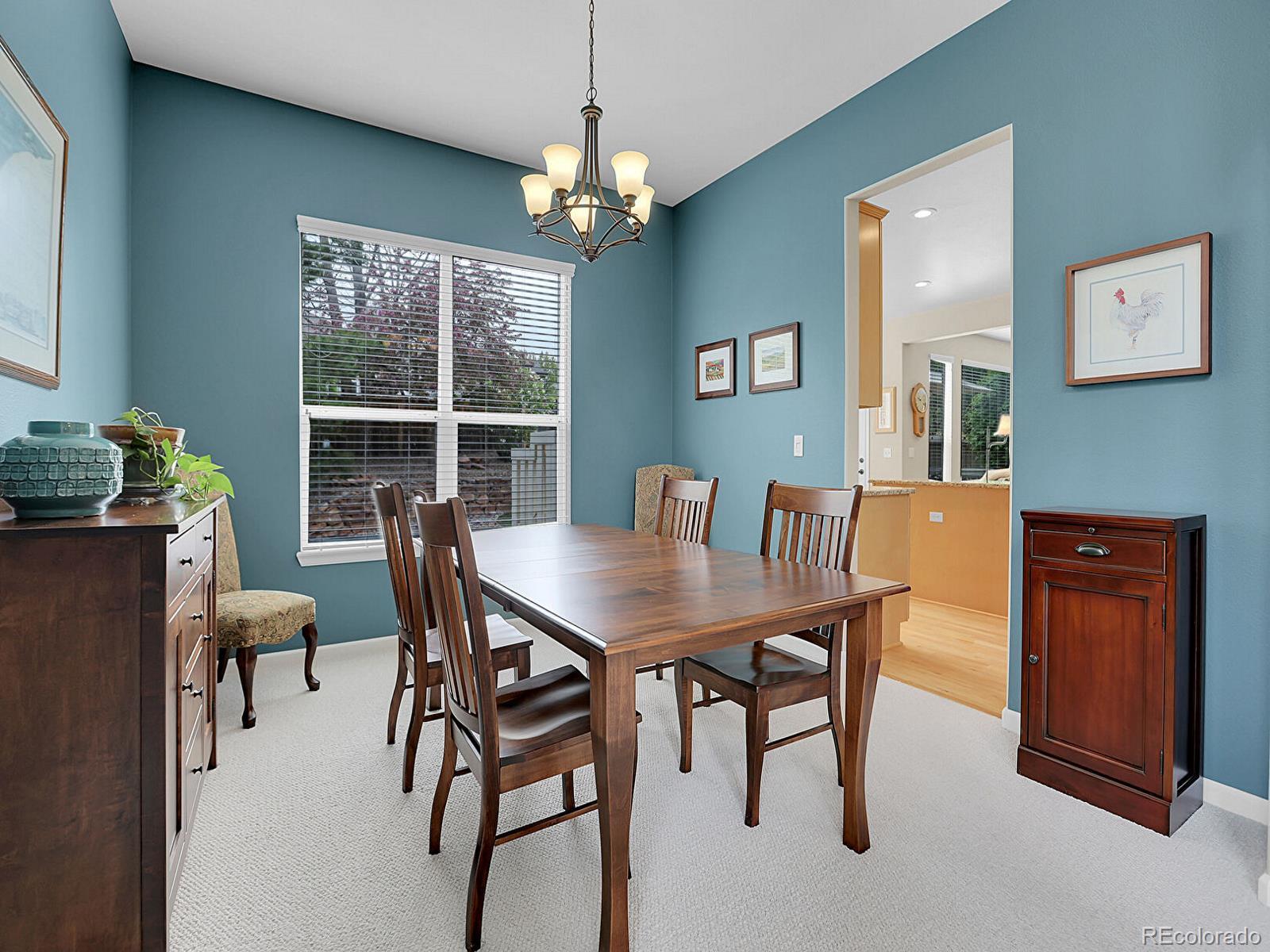 7138 Mountain Brush Circle Highlands Ranch, CO 80130 - Photo 16 of 50 a view of a dining room with furniture window and wooden floor