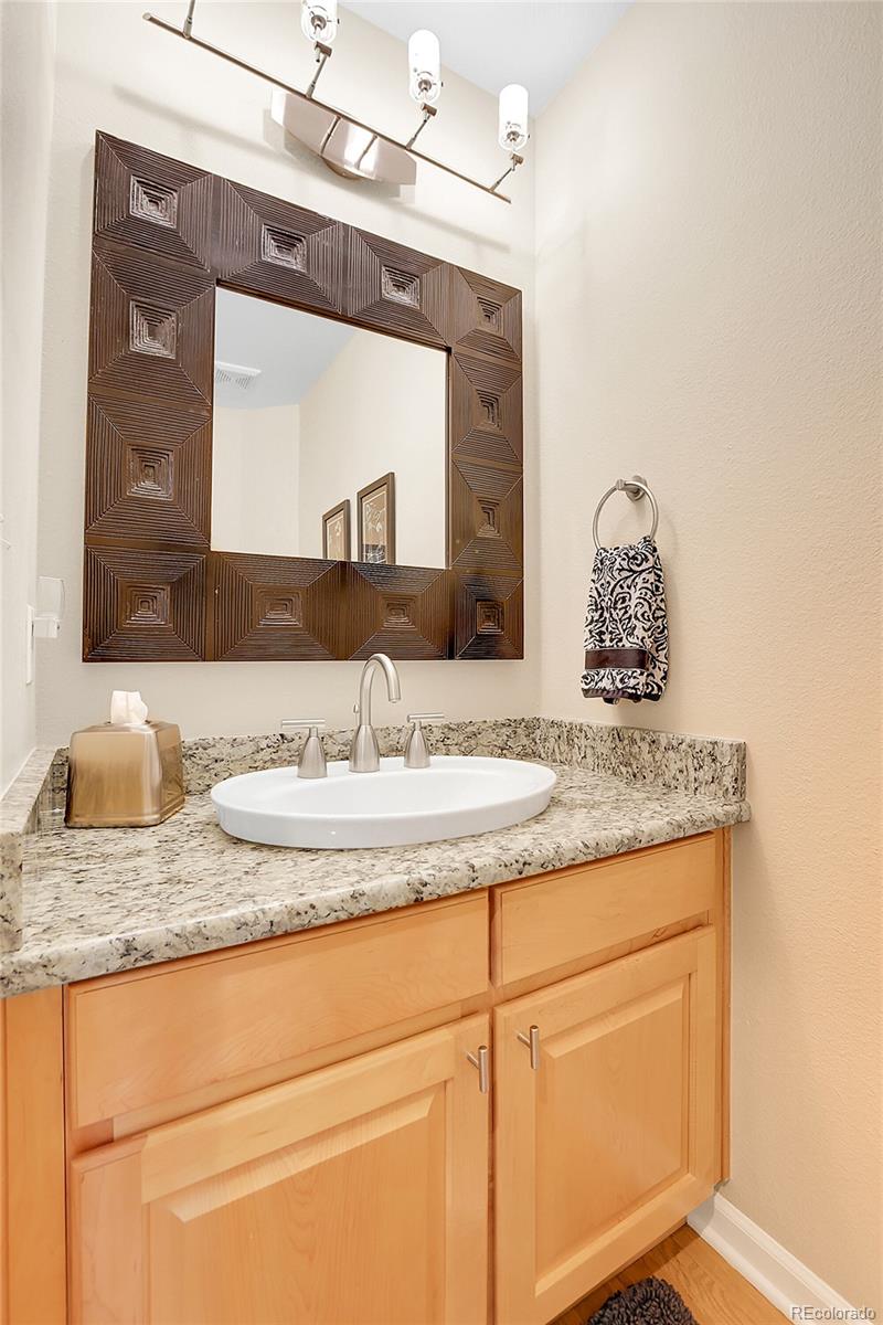 7138 Mountain Brush Circle Highlands Ranch, CO 80130 - Photo 19 of 50 a bathroom with a granite countertop sink and a mirror
