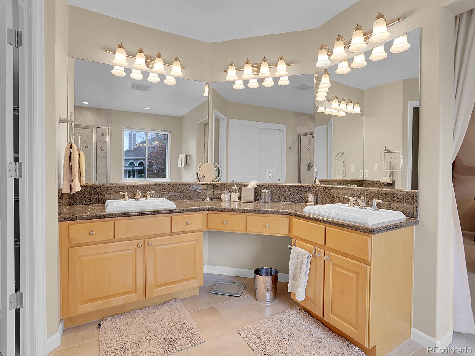 7138 Mountain Brush Circle Highlands Ranch, CO 80130 - Photo 26 of 50 a bathroom with a sink vanity and a mirror