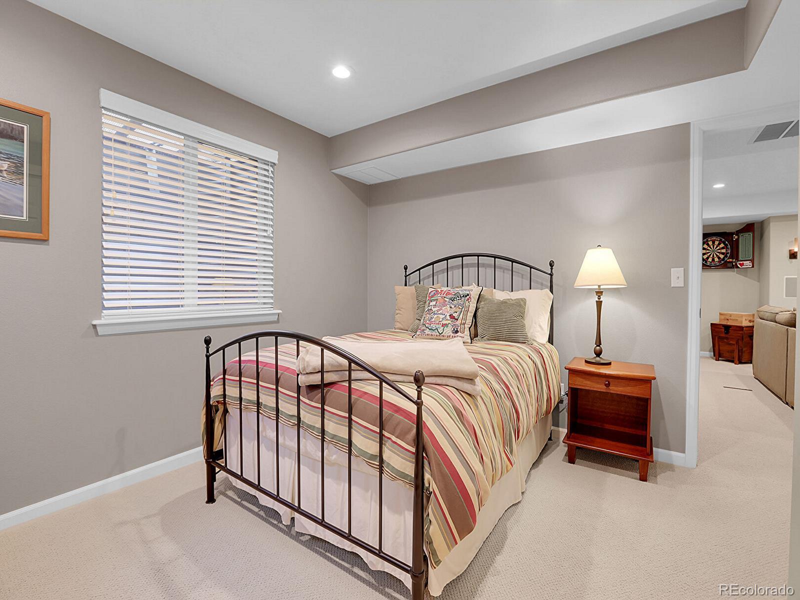 7138 Mountain Brush Circle Highlands Ranch, CO 80130 - Photo 40 of 50 a bedroom with a bed and a window