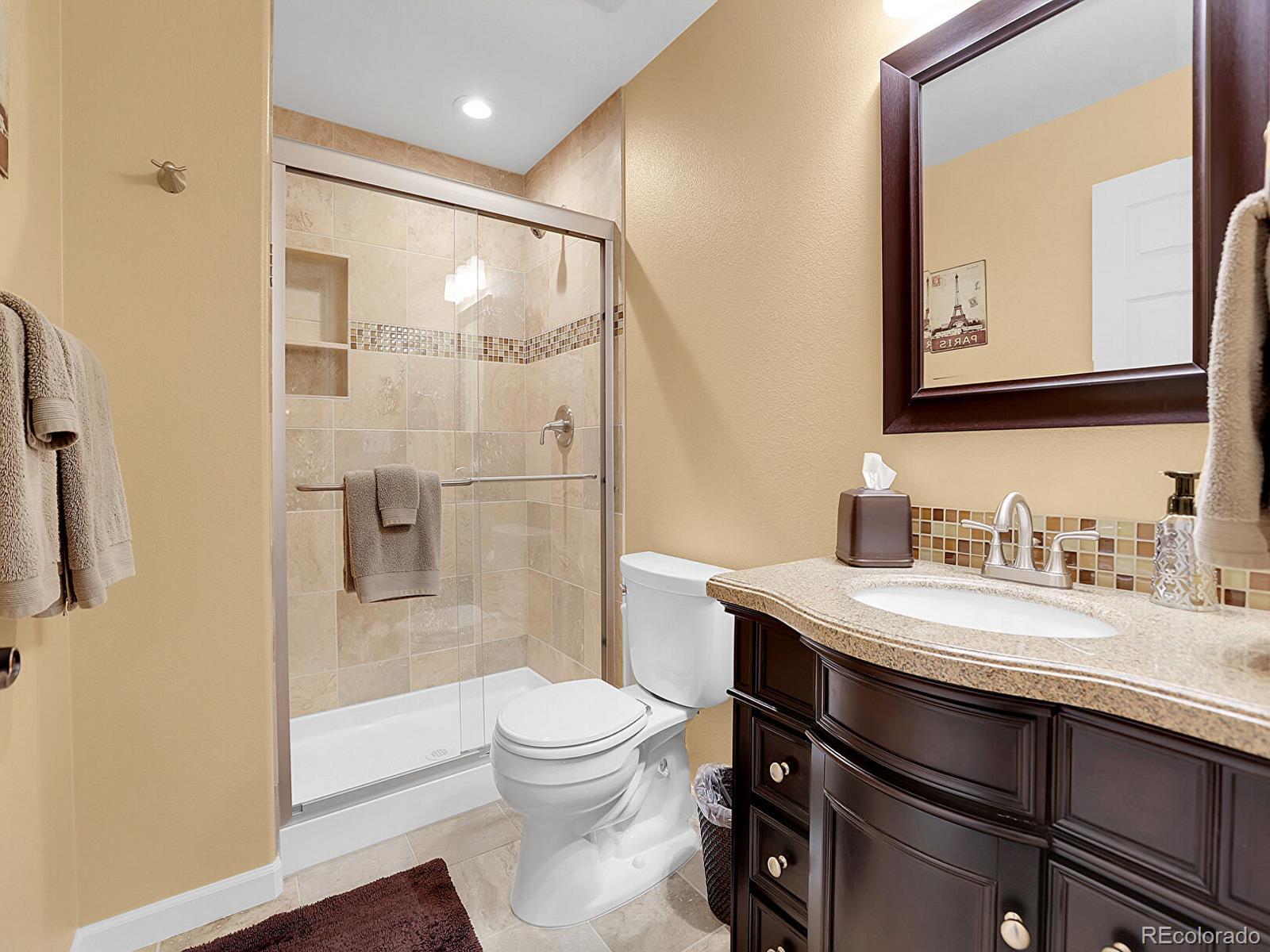 7138 Mountain Brush Circle Highlands Ranch, CO 80130 - Photo 41 of 50 a bathroom with a sink a toilet and shower