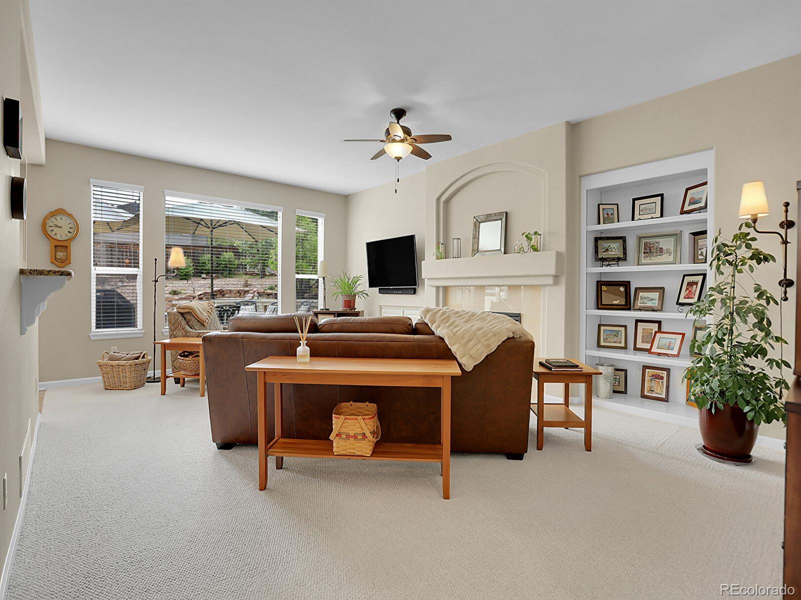 7138 Mountain Brush Circle Highlands Ranch, CO 80130 - Photo 7 of 50 a living room with furniture and a fireplace