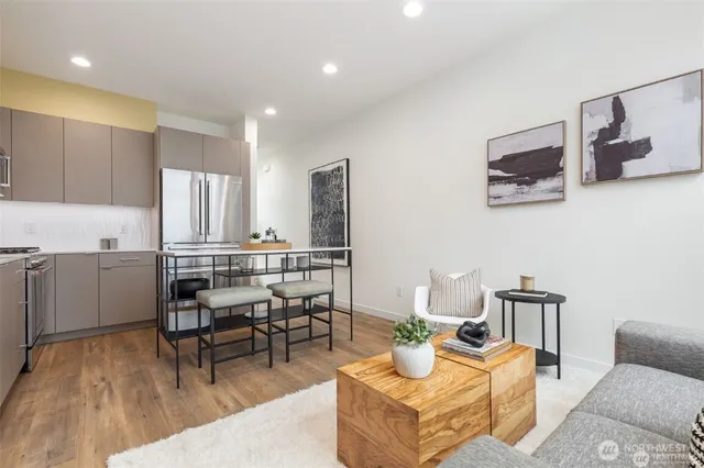 a living room with furniture and a dining table with kitchen view