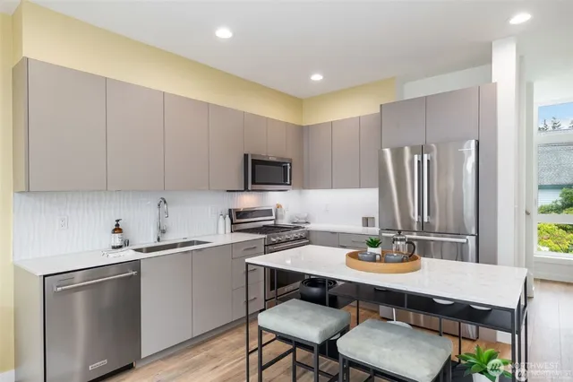 a kitchen with a sink cabinets and appliances
