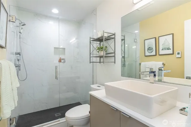 a bathroom with a sink toilet and shower