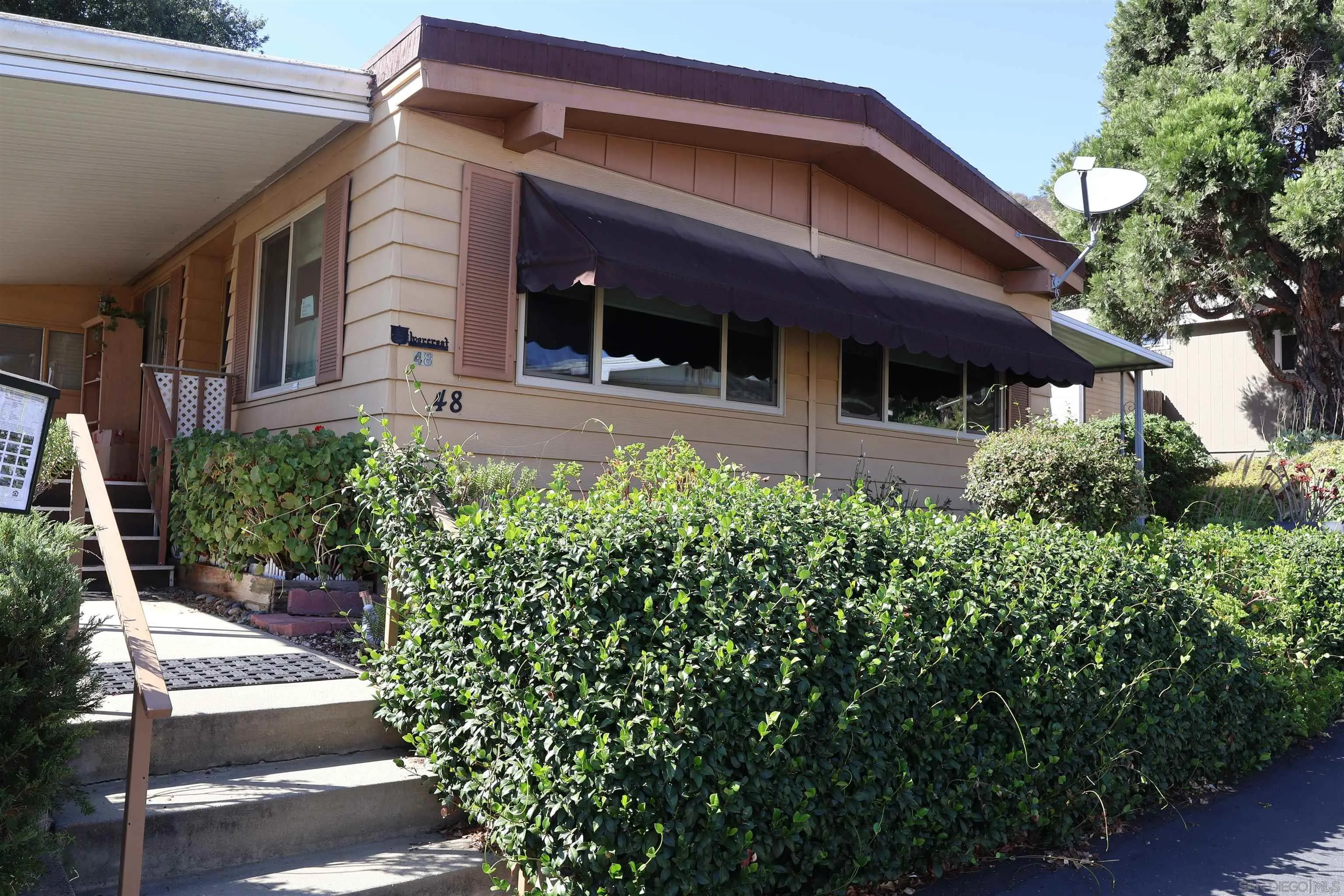 4747 Oak Crest Road, Unit 48 Fallbrook, CA 92028 - Photo 2 of 22 a view of house with backyard and garden