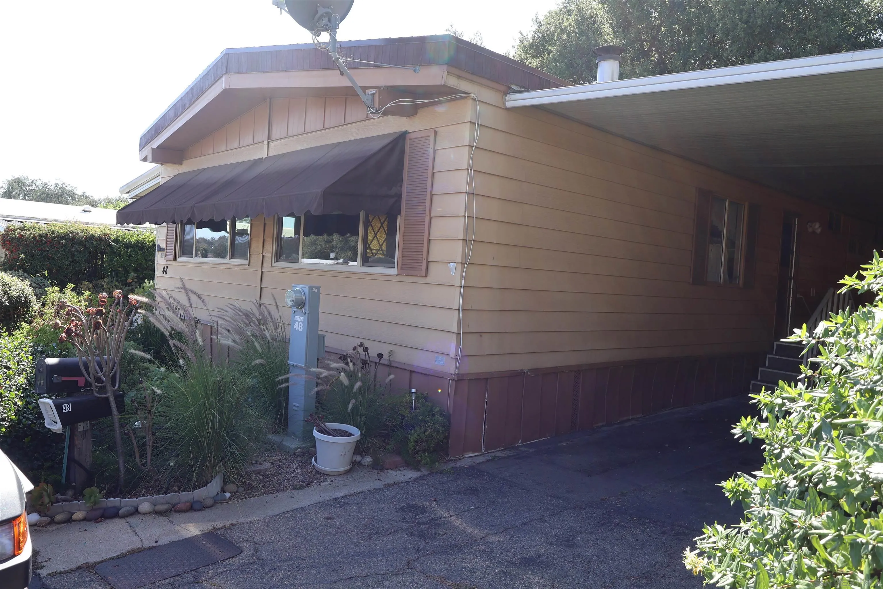 4747 Oak Crest Road, Unit 48 Fallbrook, CA 92028 - Photo 3 of 22 a view of a house with a yard