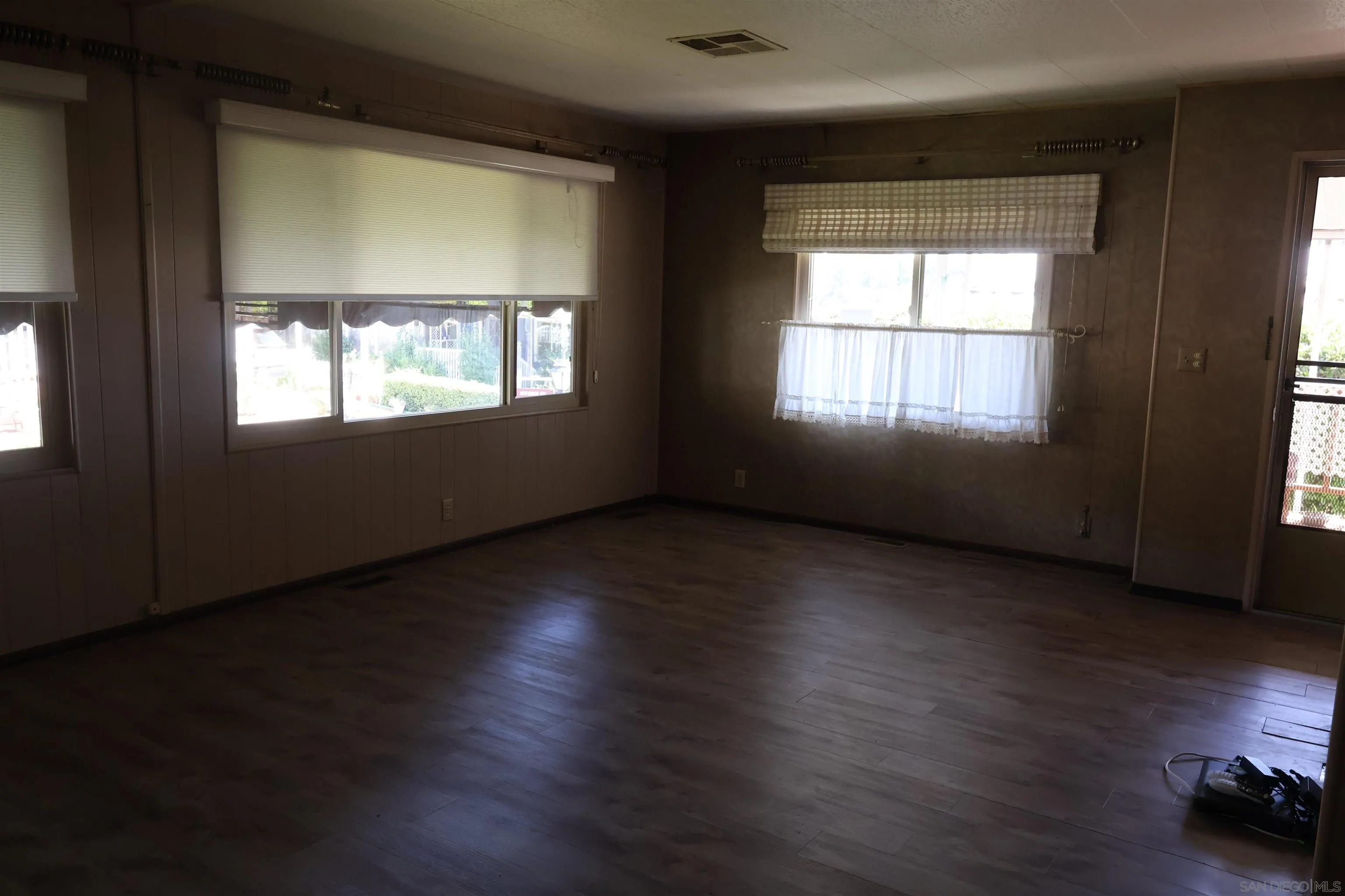 4747 Oak Crest Road, Unit 48 Fallbrook, CA 92028 - Photo 6 of 22 an empty room with wooden floor and windows