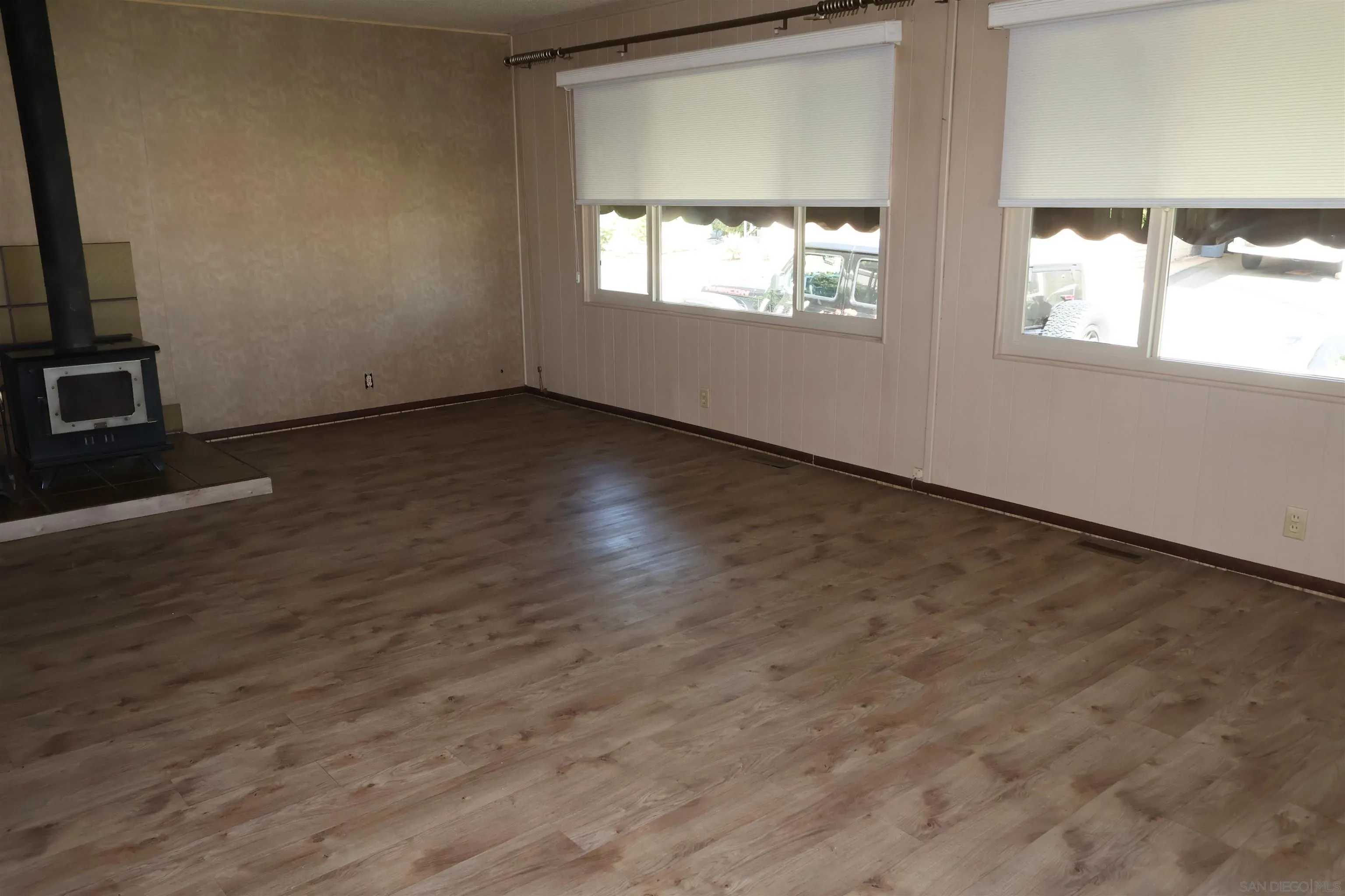 4747 Oak Crest Road, Unit 48 Fallbrook, CA 92028 - Photo 7 of 22 an empty room with wooden floor and windows