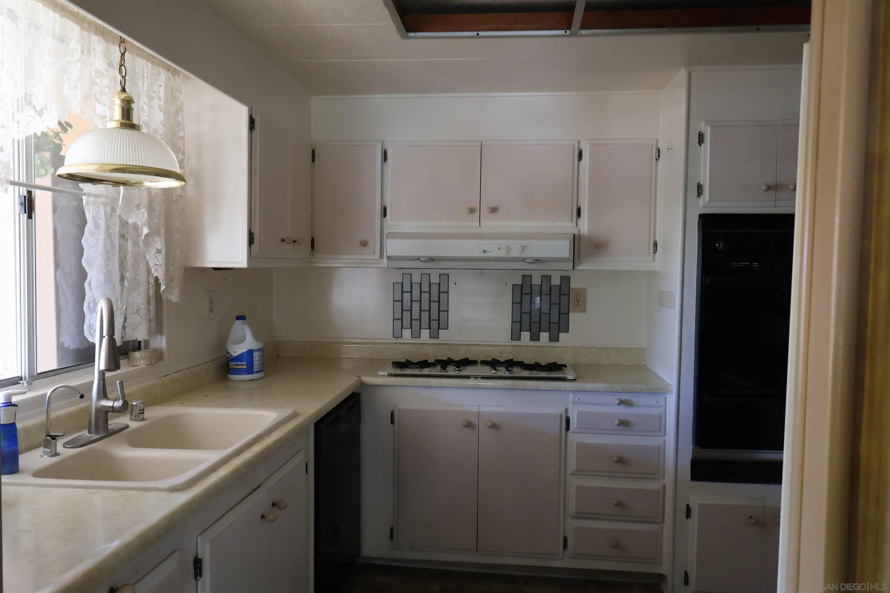 4747 Oak Crest Road, Unit 48 Fallbrook, CA 92028 - Photo 10 of 22 a kitchen with kitchen island granite countertop a sink and cabinets