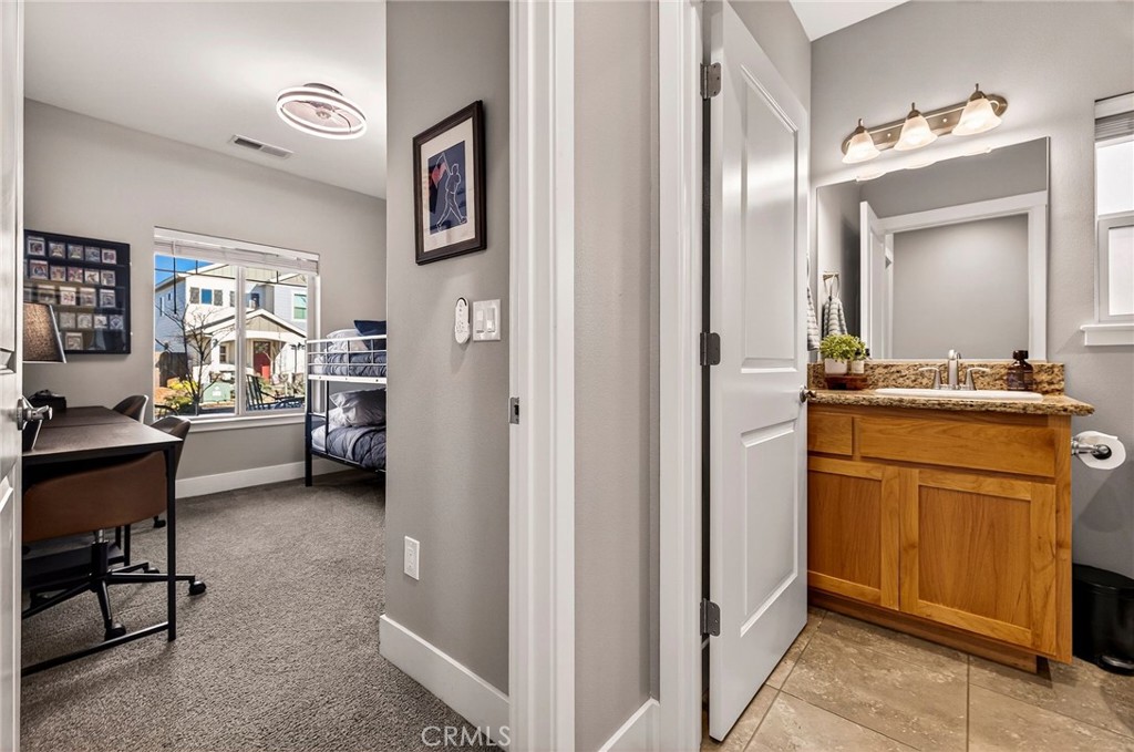 2855 Pin Oak Lane Chico, CA 95928 - Photo 22 of 48 a en suite bathroom with a double vanity sink and a mirror
