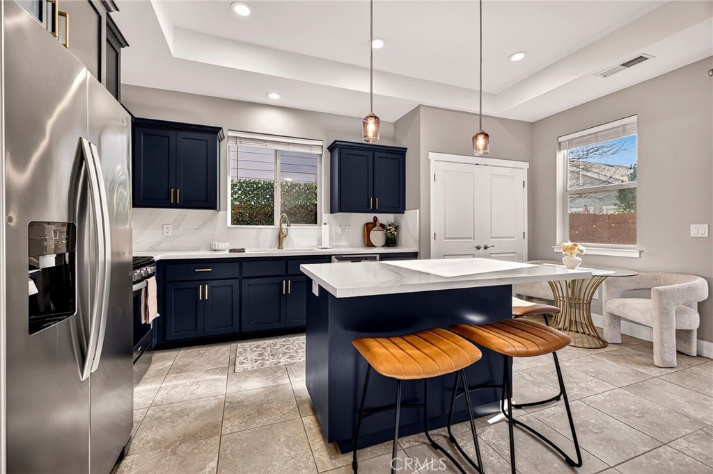 2855 Pin Oak Lane Chico, CA 95928 - Photo 3 of 48 a large kitchen with kitchen island a counter space a sink stainless steel appliances and cabinets