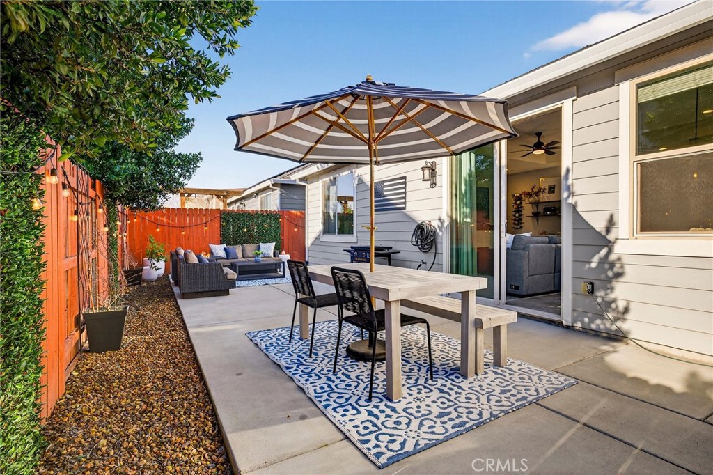 2855 Pin Oak Lane Chico, CA 95928 - Photo 35 of 48 a view of a patio with a table and chairs under an umbrella