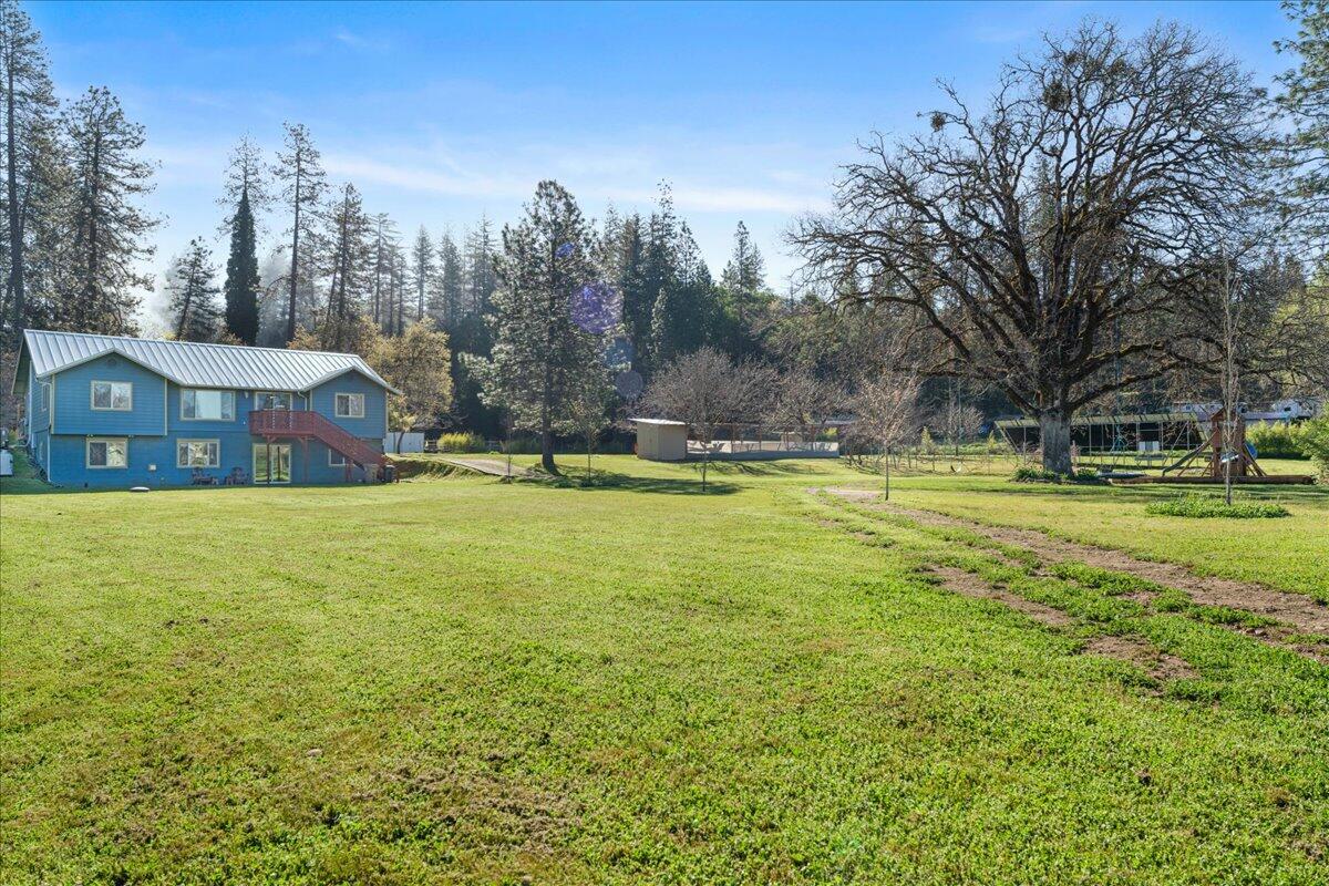 649 Pleasant Valley Road Merlin, OR 97532 - Photo 3 of 57 a view of a house with a big yard and large trees