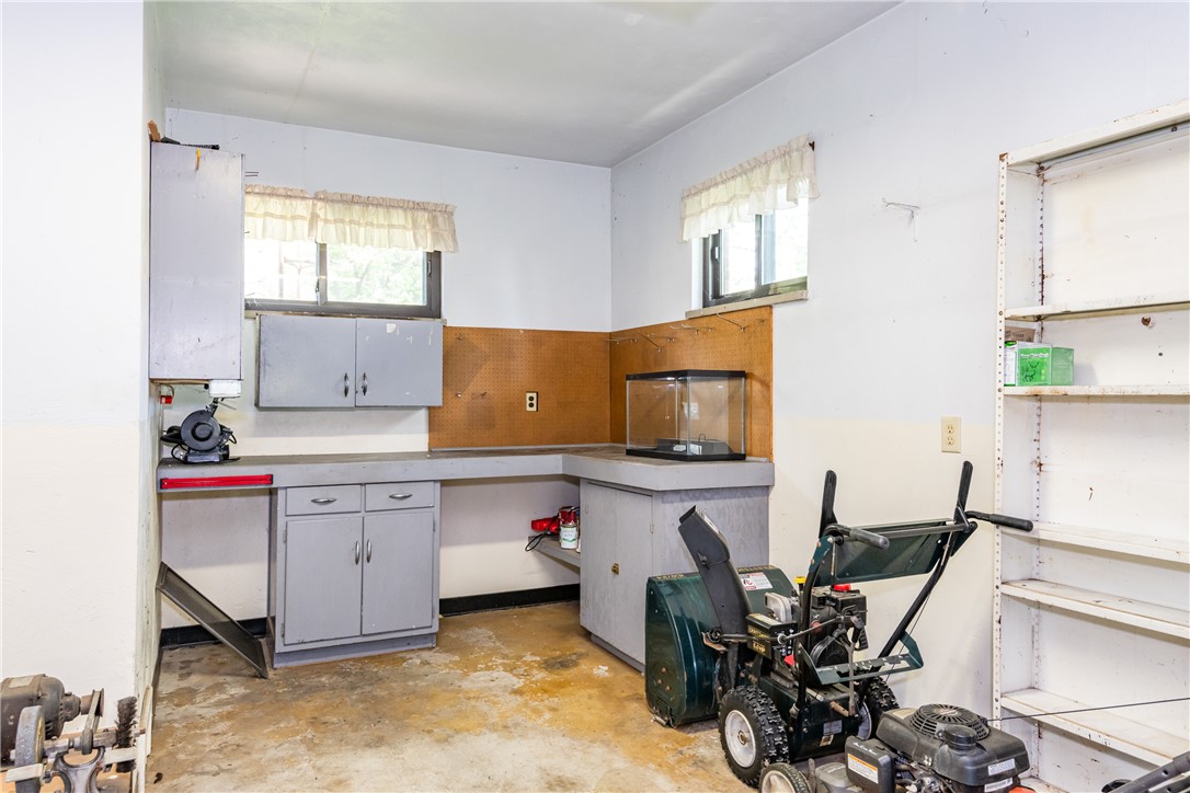 1176 Geneva Road Dayton, OH 45434 - Photo 36 of 55 This functional workshop space offers ample storage and work surfaces for various projects.