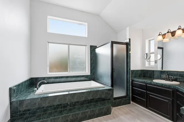 a bathroom with bathtub and window
