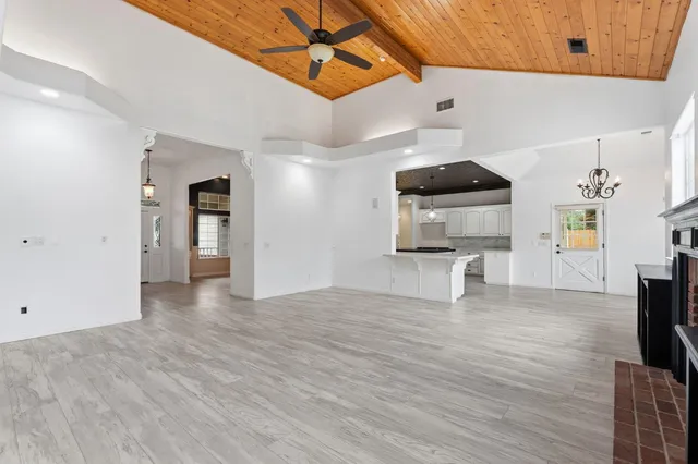 a view of a livingroom with a fireplace and wooden floor