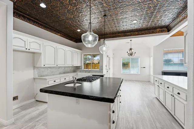 a kitchen with stainless steel appliances granite countertop a sink and dishwasher with wooden floor