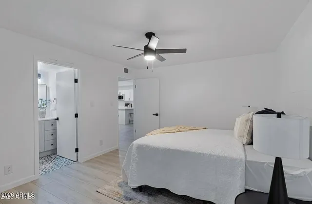 a bathroom with a sink and mirror with toilet
