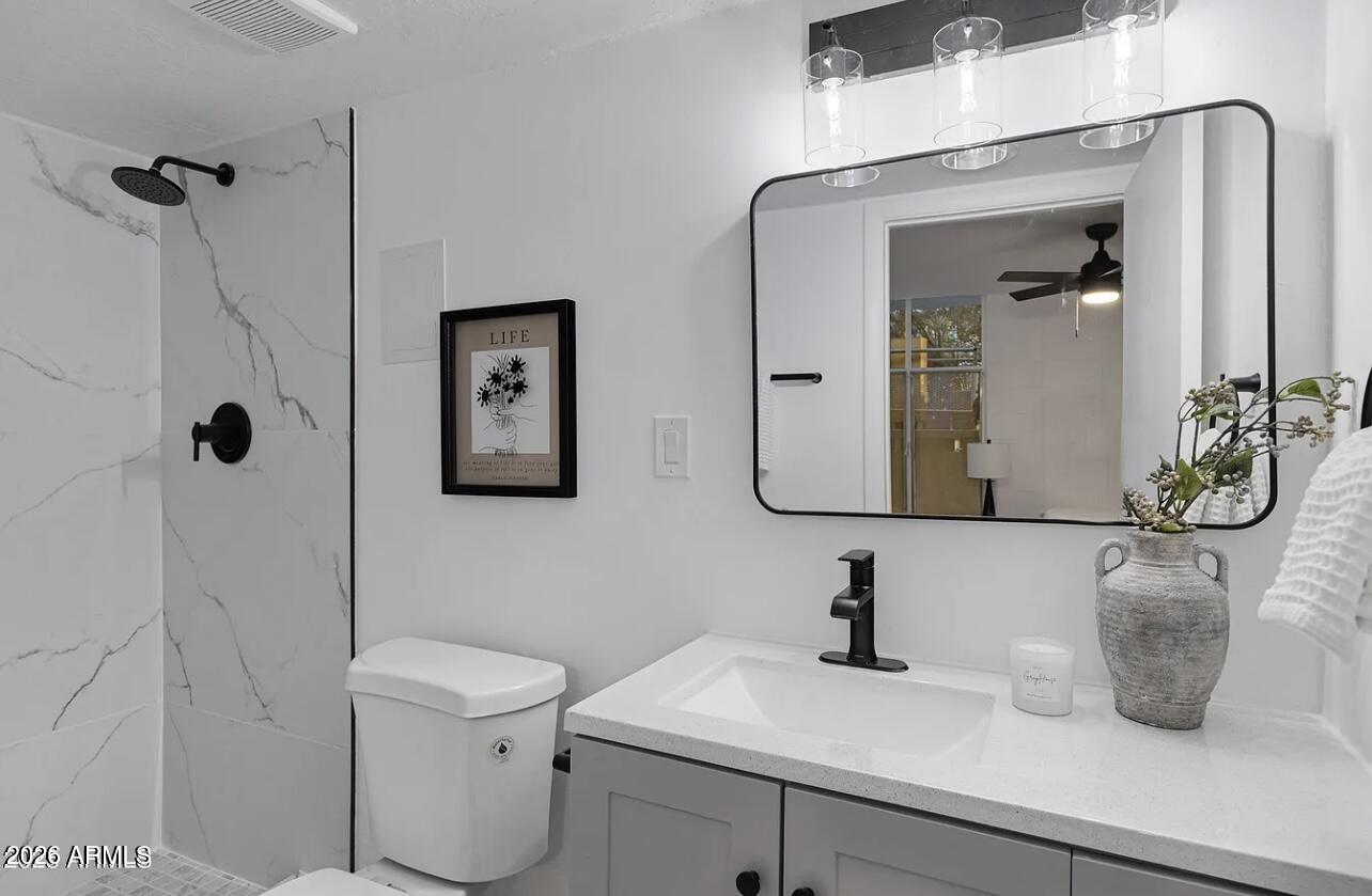 1101 East Bethany Home Road, Unit 15 Phoenix, AZ 85014 - Photo 13 of 16 a bathroom with a sink and mirror with toilet